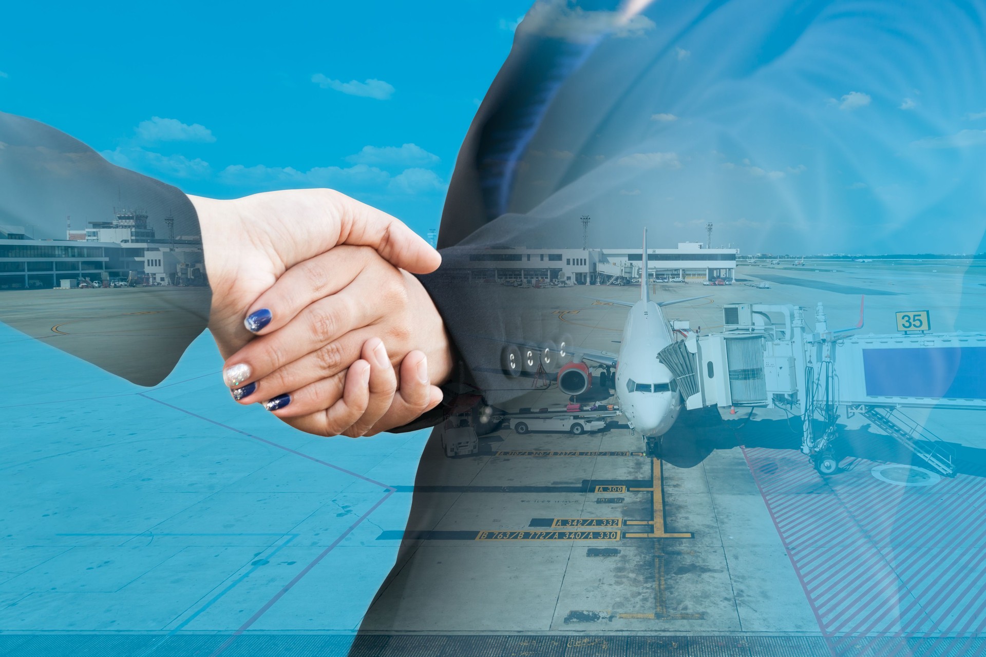 Double exposure of businesspeople handshake with aeroplane